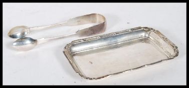 A silver hallmarked card tray and silver pair of t