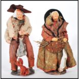 A pair of pottery made Simone Jouglas figures in t