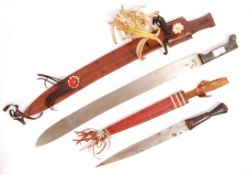 TWO 20TH CENTURY TRIBAL HAND WEAPONS; DAGGER AND MACHETE