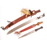 TWO 20TH CENTURY TRIBAL HAND WEAPONS; DAGGER AND MACHETE