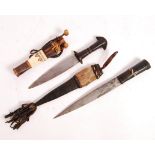 TWO EARLY 20TH CENTURY AFRICAN LEATHER WORKED ARM DAGGERS