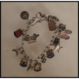 A vintage silver charm bracelet having a curb link chain with a heart padlock having fifteen