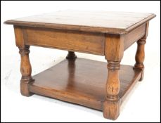 A good 20th Century oak coffee table in the manner of Brights of Nettlebed, flared square top raised