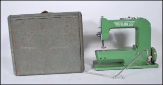 A vintage 1940's Elna 'Grasshopper' sewing machine in original green paint, within a fitted metal