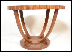 A early 20th Century Art Deco oak top hall table of circular form having applied walnut panels to