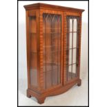 A 20th Century mahogany twin door display / china cabinet, twin full length astral glazed doors