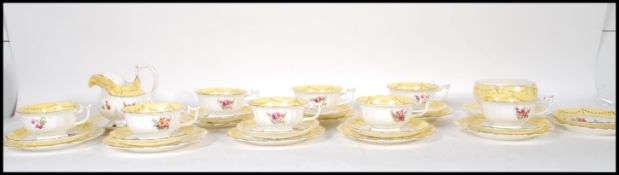 A 20th Century porcelain tea service, each piece decorated with different floral sprays having