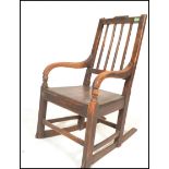 A 19th Century Georgian beech and elm rocking chair, shaped reeded splayed backrest with shaped