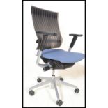 A contemporary Orangebox swivel desk chair having a blue upholstered seat with a reeded black