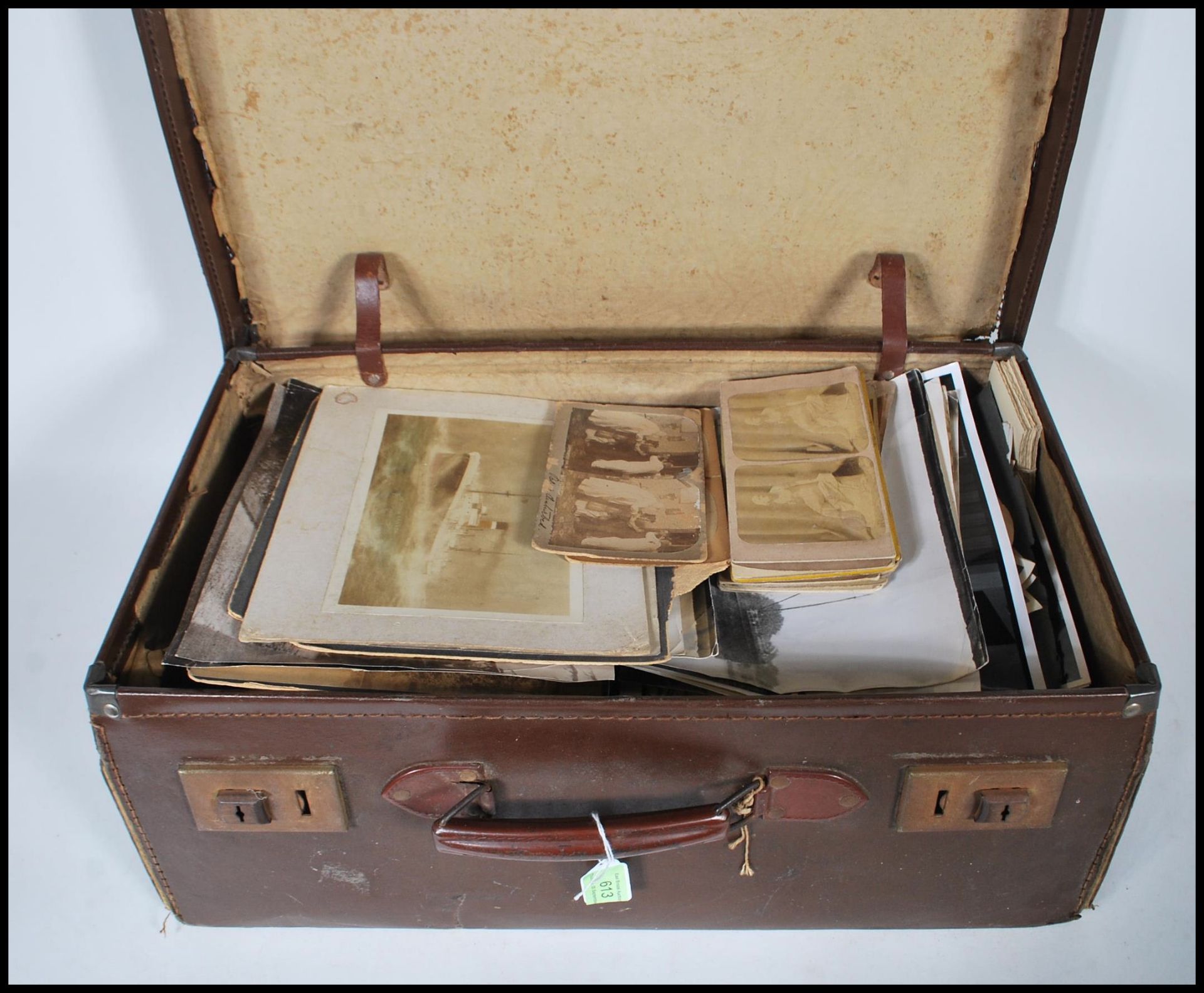 A Vintage Cowhide leather suitcase containing hundreds of black & white photographs. Sizes range
