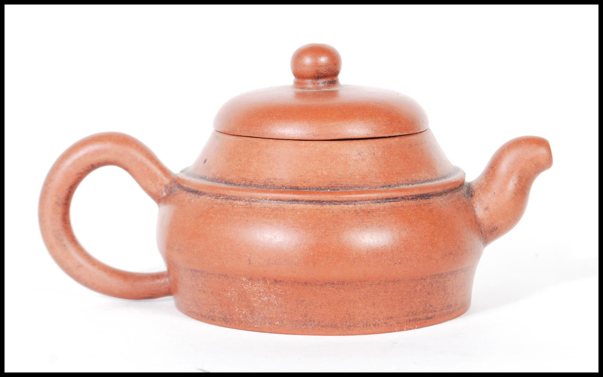 An early 20th Century Chinese Yixing teapot modelled in a brown clay with shaped handle and spout. - Image 3 of 7