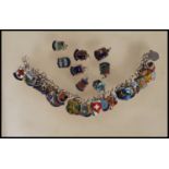 A vintage sterling silver souvenir / charm bracelet having a large number of silver enamelled