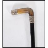A 19th Century Victorian ebonised walking stick cane having a silver collar and end with engraved