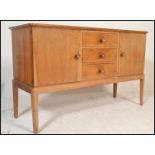 An original mid century Gordon Russell walnut sideboard / credenza. Raised on squared legs with a