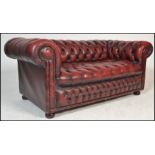 A good 20th Century Victorian style deep-buttoned back Chesterfield sofa with red leather /