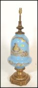 A large antique style bulbous blue glass and brass table lamp. Of Neo classical design on blue