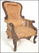 A 19th Century Victorian mahogany framed armchair of spoon back form with scroll arms with carved