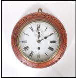 An Antique early 20th Century carved hanging wall clock having white enamel face with Roman