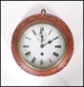 An Antique early 20th Century carved hanging wall clock having white enamel face with Roman