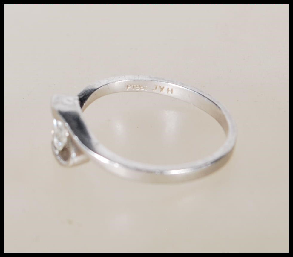 A 950 platinum solitaire diamond ring having an openwork swirl mount set with a single diamond - Image 5 of 6