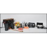 A collection of vintage cameras to include a Kodak VR35 camera, a Kodak Instamatic 33, Brownie