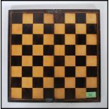 An early 19th Century folding chess / checkers gaming board constructed from contrasting wood,