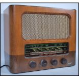 A vintage 20th century walnut cased Marconiphone radio having a glass panel to front with bakelite