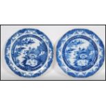 A pair of 19th Century English pearlware blue and white printed plates depicting with a landscape