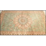A large Persian floor carpet Keshan rug having a green ground with geometric borders and central