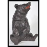 A 20th Century German Black Forest hand carved wooden tobacco pot or tea caddy in the form of a bear