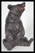 A 20th Century German Black Forest hand carved wooden tobacco pot or tea caddy in the form of a bear