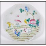 A 19th century Chinese ceramic Wucai footed dish of octagonal form being hand painted and enameled
