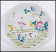 A 19th century Chinese ceramic Wucai footed dish of octagonal form being hand painted and enameled