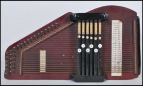 A vintage 20th Century wooden Autoharp musical instrument. Measures 47cm long by 26cm wide.