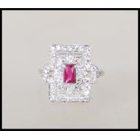 A sterling silver ladies Art Deco style dress ring of rectangular form having a central ruby with cz