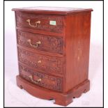 A 20th century contemporary hardwood marquetry inlaid chest of four drawers. The chest having