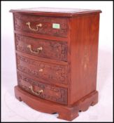 A 20th century contemporary hardwood marquetry inlaid chest of four drawers. The chest having