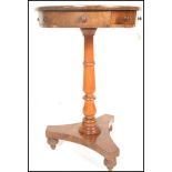 A 19th Century drum end pedestal table raised on a central knopped column terminating in tripod