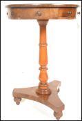 A 19th Century drum end pedestal table raised on a central knopped column terminating in tripod