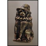 A novelty brass vesta case in the form of a dog wearing a hat and ruff collar. Hinged base with