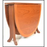 A 1970's 20th century Nathan teak wood drop leaf dining table. The full length drop leaves being