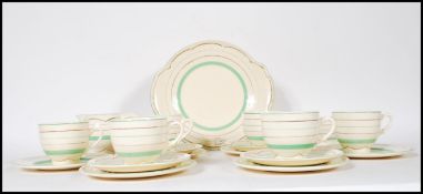 A 1920's Art Deco Clarice Cliff for Newport tea service having a cream ground with painted green and