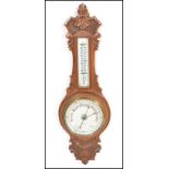 An early 20th Century 1930's oak cased Aneroid barometer having carved floral work to case. Set with