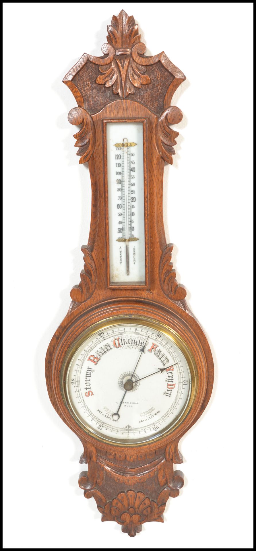 An early 20th Century 1930's oak cased Aneroid barometer having carved floral work to case. Set with