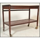 A retro 20th century Danish influence teak wood metamorphic two tier  buffet trolley raised on