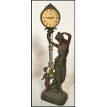 A contemporary Juliana figural pendulum quartz clock, the movement held aloft by a classical style