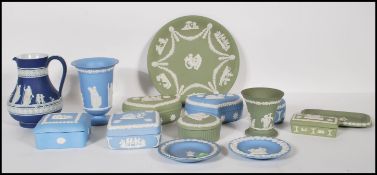A collection of 14 pieces of Wedgwood jasperware ceramics to include a cobalt jug dating to the late