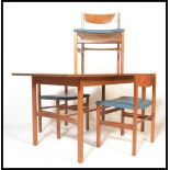 A retro 20th Century teak wood Danish inspired dining suite, consisting of extendable dining table