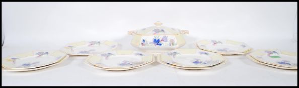 A vintage Art Deco 1930's dinner service having a paneled yellow Clarice Cliff style crocus