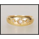 A hallmarked 18ct gold gypsy ring set with three round cut diamonds. Hallmarked Chester 1913. Weight